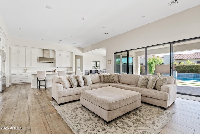 living area with visible vents and light wood-type flooring