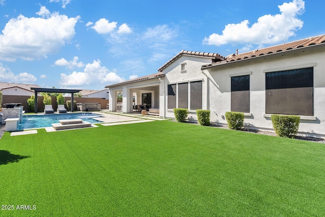 back of house featuring a fenced in pool, a jacuzzi, a yard, and a patio area