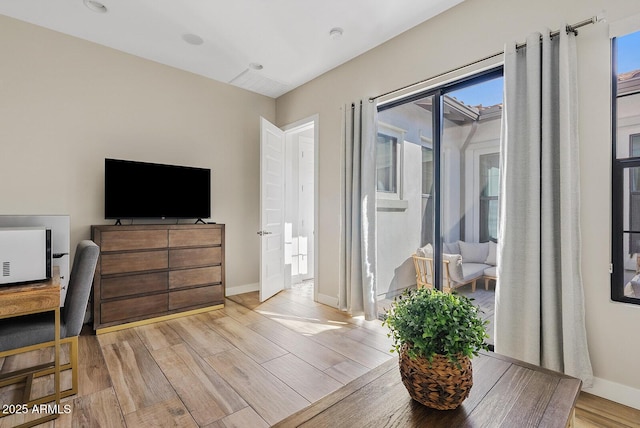 interior space featuring light wood-style floors and baseboards
