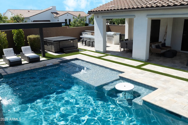 view of pool featuring area for grilling, exterior bar, a hot tub, a fenced in pool, and a patio
