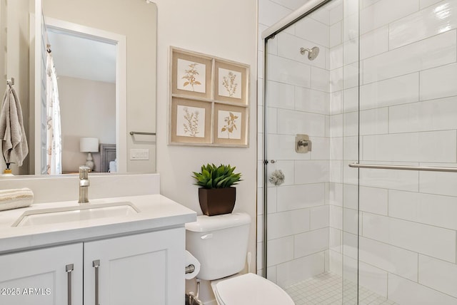 full bath with vanity, a stall shower, and toilet