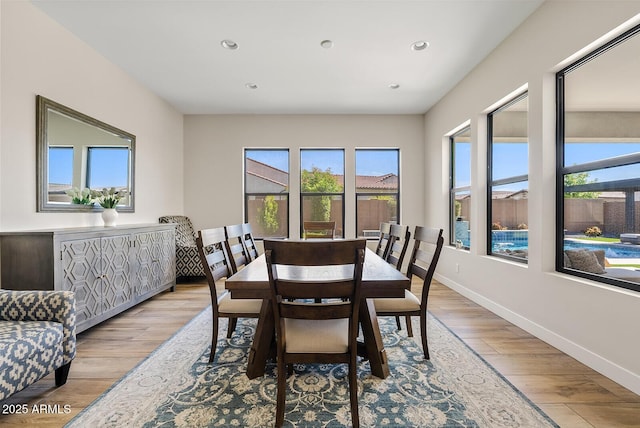 dining space with recessed lighting, baseboards, and light wood finished floors