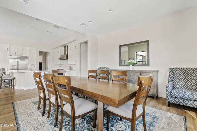 dining room featuring recessed lighting, light wood finished floors, and visible vents