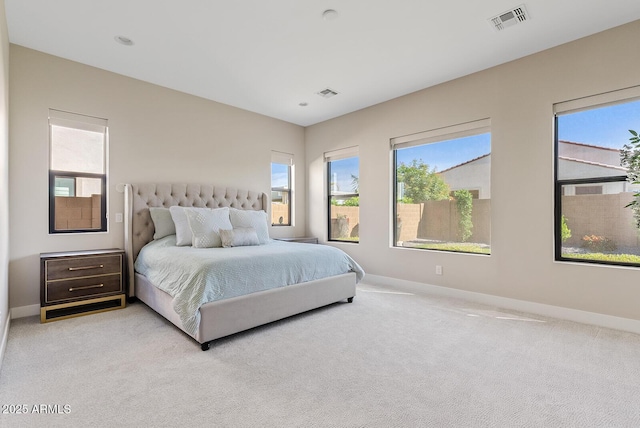 bedroom featuring visible vents, carpet floors, and multiple windows