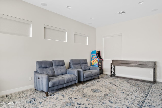 living area featuring baseboards, recessed lighting, and visible vents