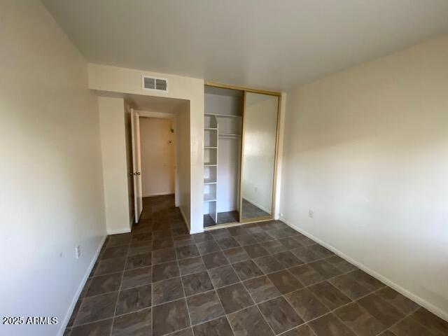 27 W Concorda Dr Unit 104, Tempe, AZ 85282 - unfurnished bedroom featuring a closet and baseboards