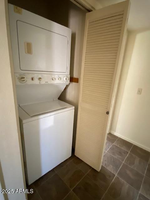 27 W Concorda Dr Unit 104, Tempe, AZ 85282 - laundry area with stacked washer and clothes dryer and dark tile patterned flooring