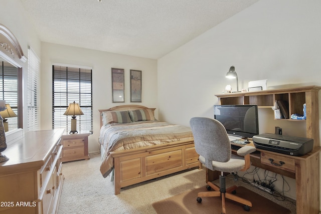 bedroom featuring a textured ceiling and light colored carpet