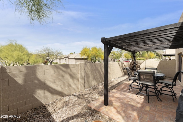 view of patio / terrace featuring outdoor dining space, a fenced backyard, and a pergola