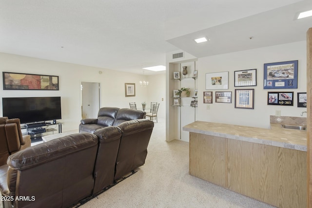 living area featuring a chandelier and visible vents