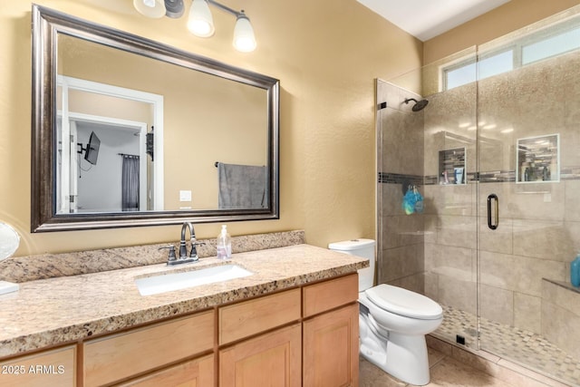 bathroom featuring tile patterned flooring, a shower stall, toilet, and vanity