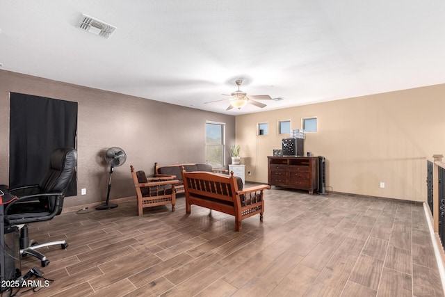 bedroom with ceiling fan, wood finish floors, visible vents, and baseboards