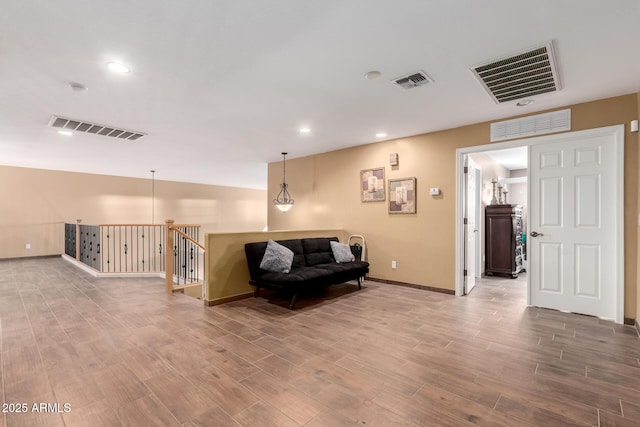 living area featuring wood finished floors and visible vents