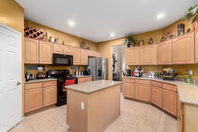 kitchen featuring light tile patterned floors, a kitchen island, light stone countertops, light brown cabinetry, and black appliances