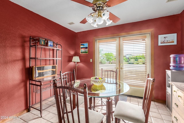 dining room featuring ceiling fan, french doors, and light tile patterned flooring