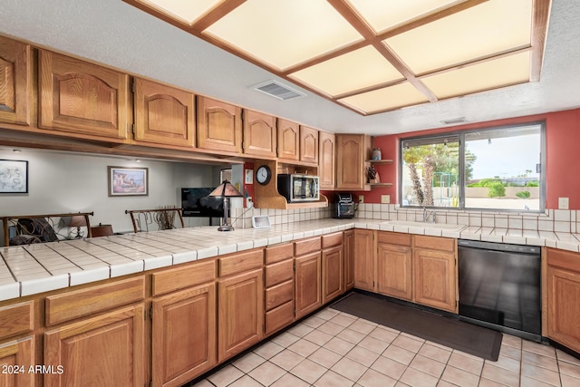 kitchen featuring tile counters, black dishwasher, sink, kitchen peninsula, and light tile patterned floors