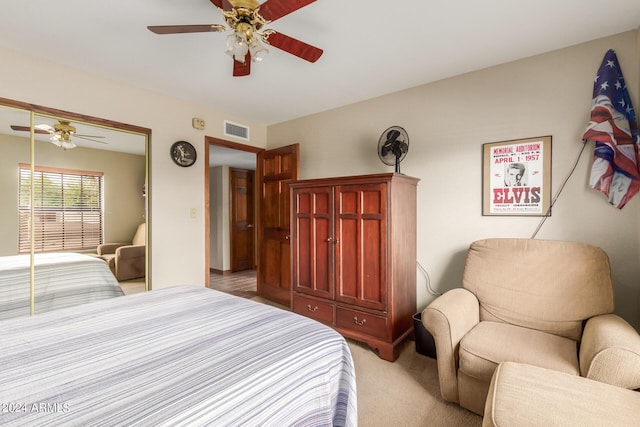 bedroom featuring light colored carpet, a closet, and ceiling fan