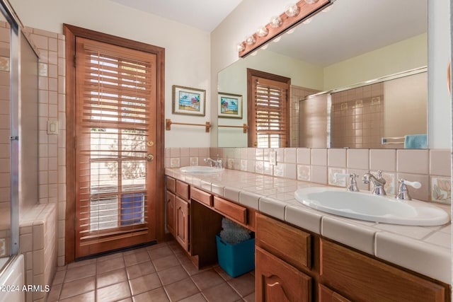 bathroom featuring tasteful backsplash, tile patterned flooring, and a wealth of natural light