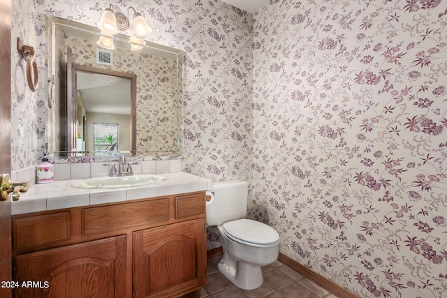 bathroom featuring tile patterned floors, vanity, and toilet