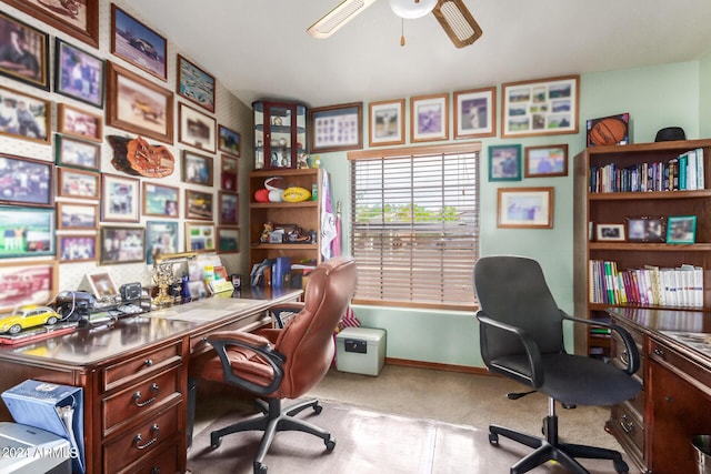 carpeted home office featuring ceiling fan