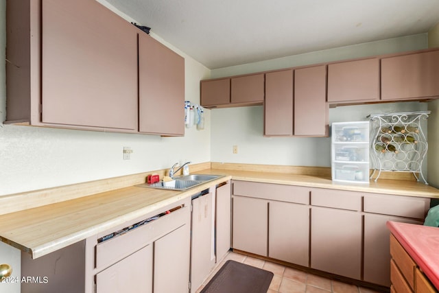 kitchen featuring sink, wood counters, and light tile patterned floors