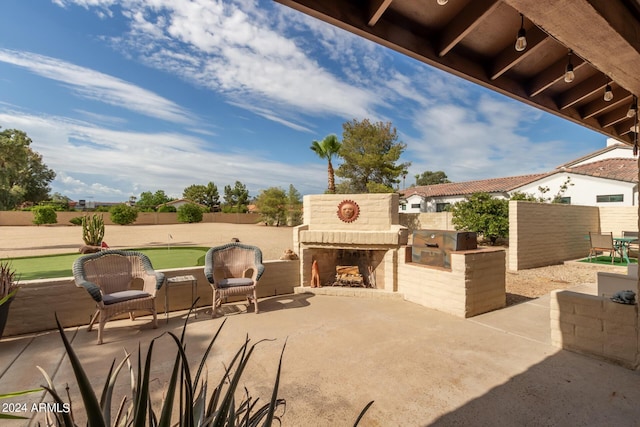 view of patio / terrace featuring an outdoor brick fireplace