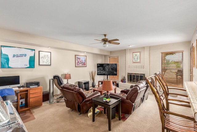 carpeted living room with ceiling fan and a brick fireplace