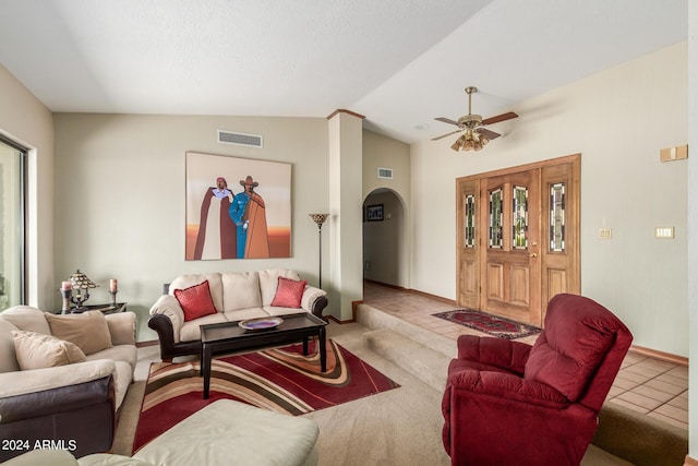 tiled living room featuring ceiling fan and lofted ceiling