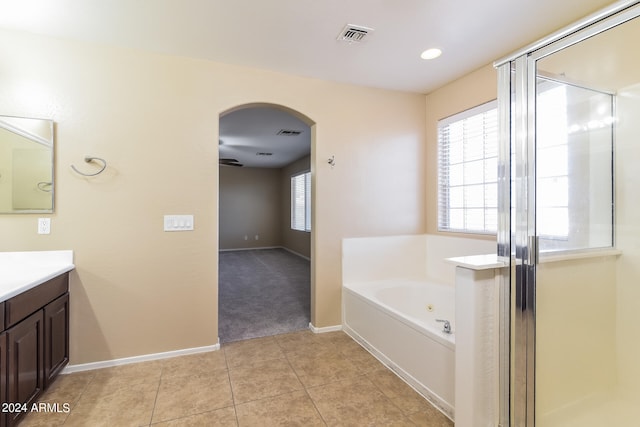 bathroom featuring vanity, plus walk in shower, and tile patterned floors