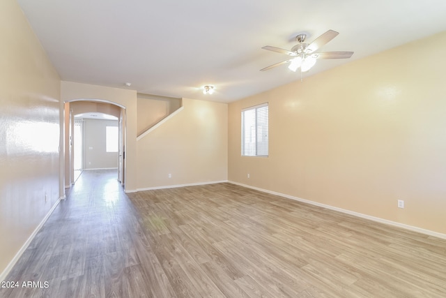 empty room with light hardwood / wood-style flooring and ceiling fan