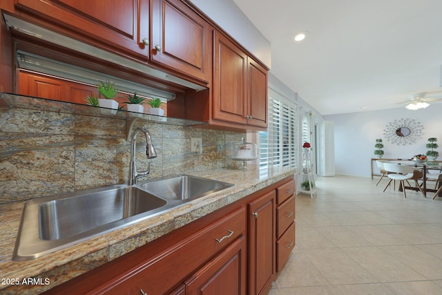 kitchen with light tile patterned flooring, recessed lighting, a sink, light countertops, and decorative backsplash