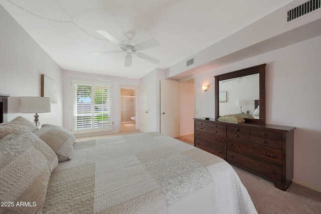 bedroom with connected bathroom, light colored carpet, visible vents, and ceiling fan