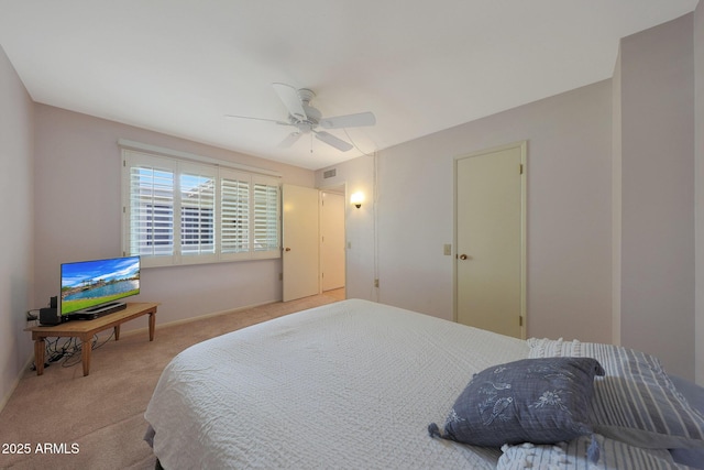 carpeted bedroom featuring visible vents and a ceiling fan