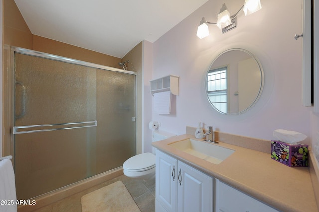 bathroom featuring a stall shower, vanity, toilet, and tile patterned floors