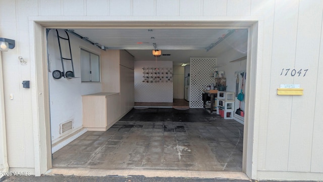 garage featuring visible vents and a garage door opener