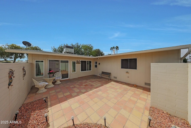 back of property with a patio area and fence