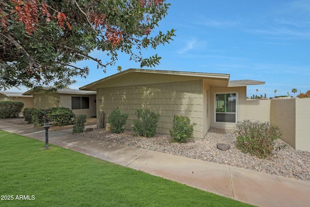 ranch-style house with a front lawn