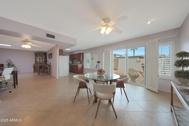 dining room with visible vents, ceiling fan, and light tile patterned floors