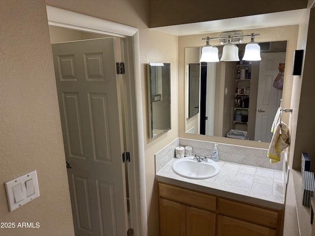 4615 N 22nd St Unit 113, Phoenix, AZ 85016 - bathroom with vanity and a textured wall