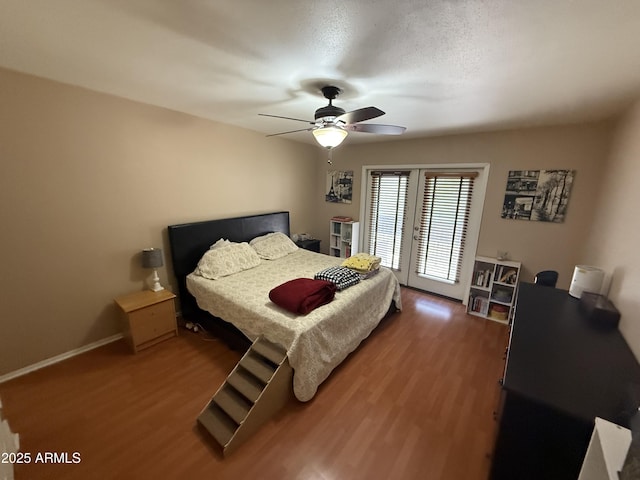 4615 N 22nd St Unit 113, Phoenix, AZ 85016 - bedroom featuring access to exterior, ceiling fan, wood finished floors, and baseboards