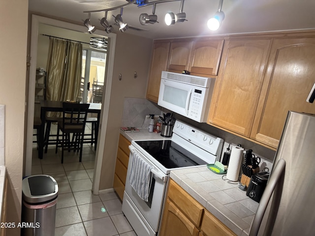 4615 N 22nd St Unit 113, Phoenix, AZ 85016 - kitchen featuring tile countertops, light tile patterned flooring, and white appliances
