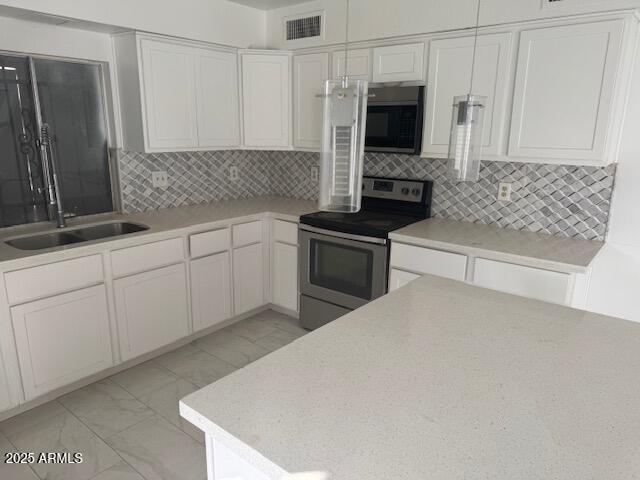 kitchen with white cabinetry, sink, and stainless steel electric range