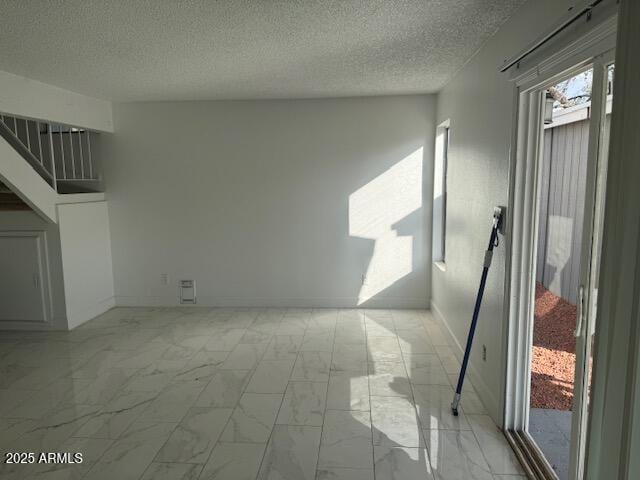 interior space with a textured ceiling