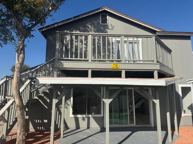 back of property with a balcony