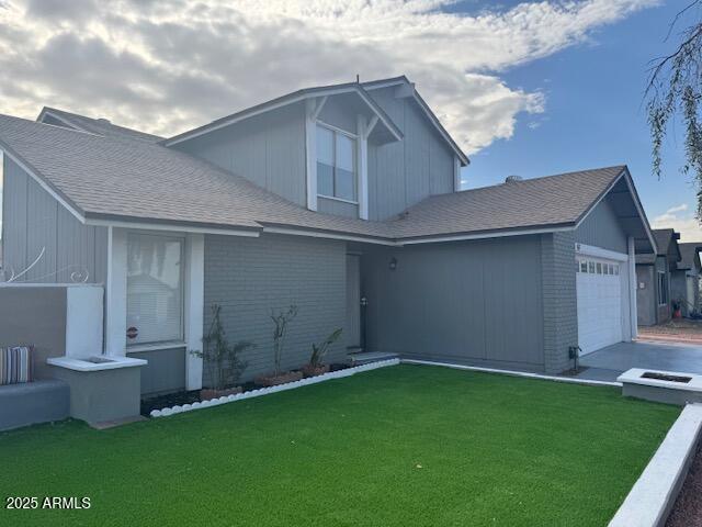 view of front of house featuring a garage and a front lawn