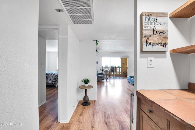 hallway with light hardwood / wood-style flooring