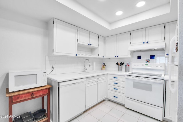 kitchen featuring sink, white appliances, backsplash, and white cabinets