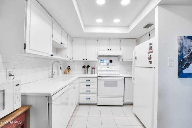 kitchen featuring white appliances, light tile patterned floors, tasteful backsplash, white cabinets, and sink