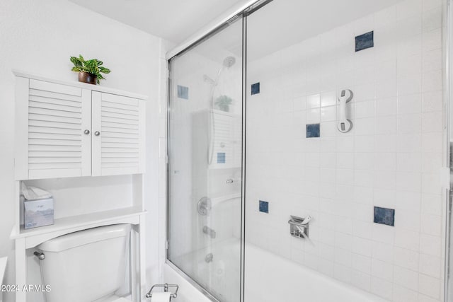 bathroom featuring shower / bath combination with glass door and toilet