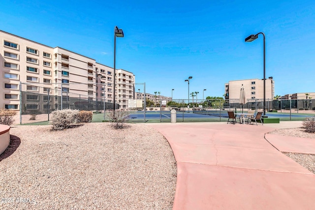 view of property's community with tennis court